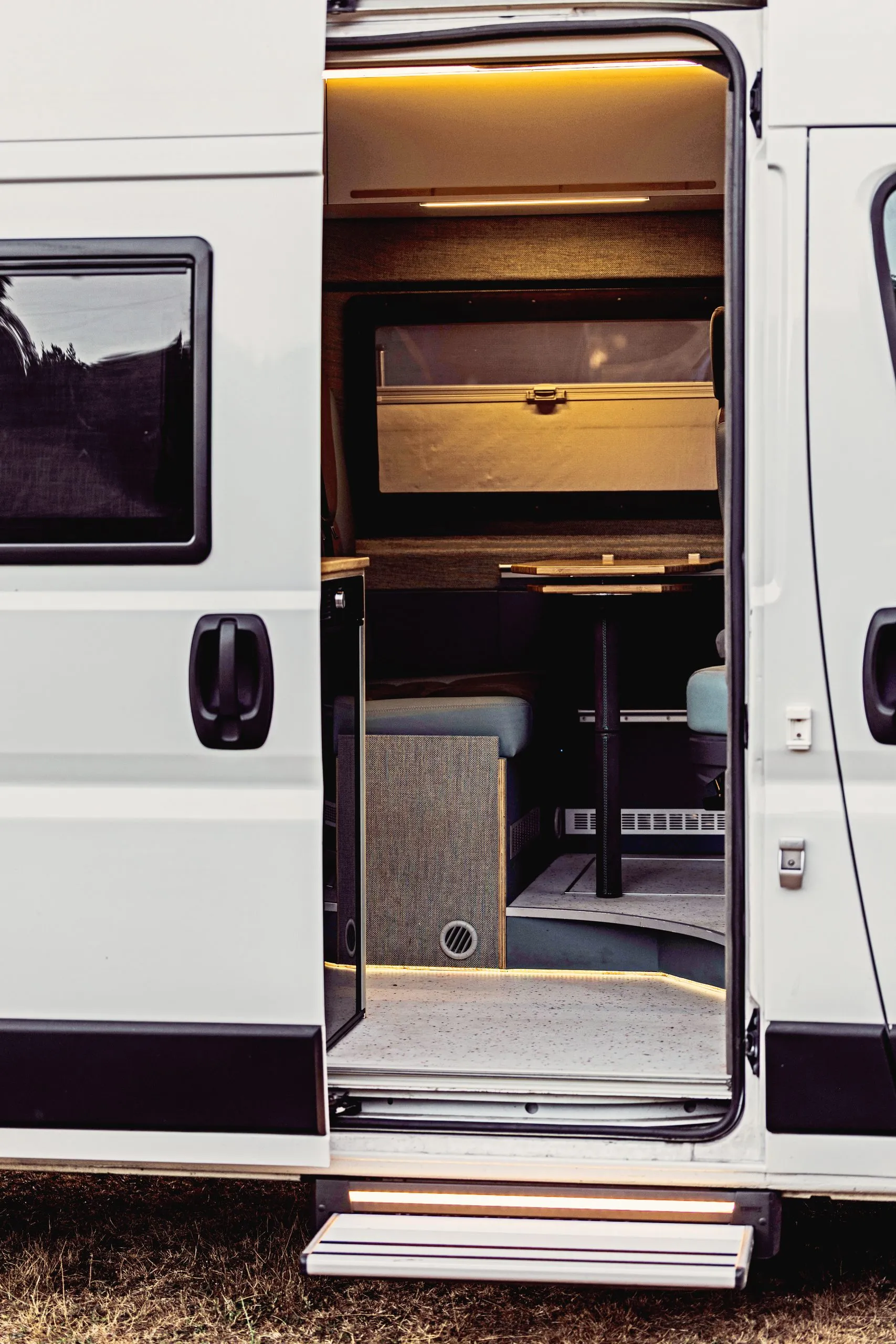 Sliding door open with warm light inside the van